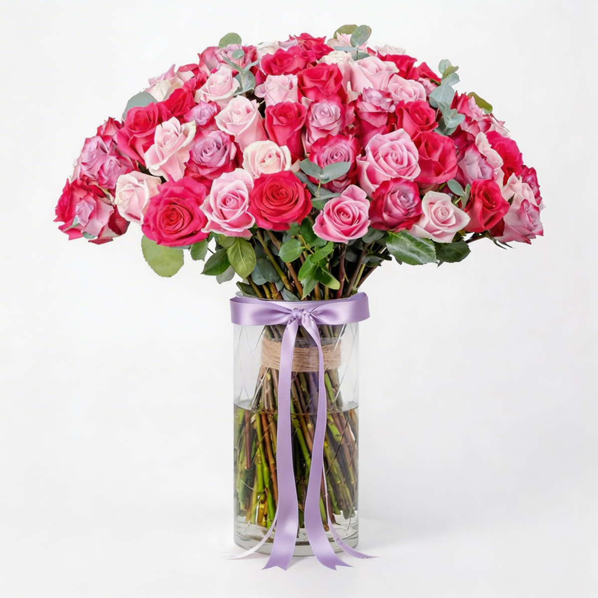 100 fresh mixed red, pink and purple roses beautifully arranged in a clear glass vase