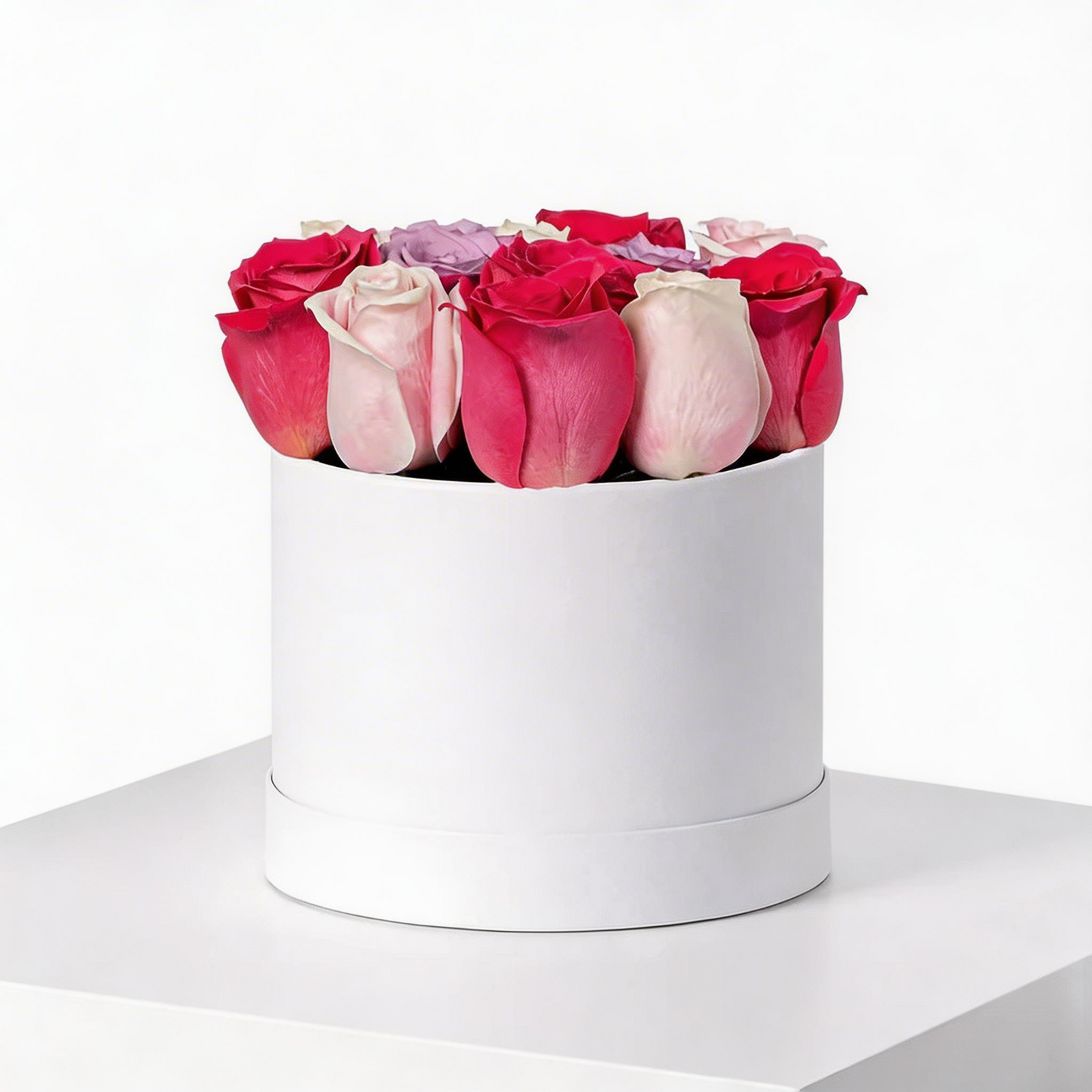 20 mixed red, pink, and purple roses arranged in a luxury white flower box with same-day flower delivery in Kuwait.