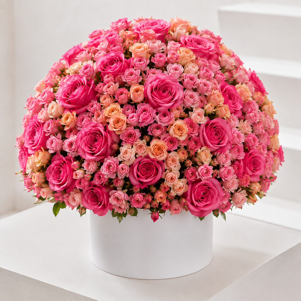 Pretty Pink & Peach Baby Rose Box with approximately 200 fresh pink roses, pink baby roses and peach baby roses arranged in a luxury white flower box for same-day flower delivery in Kuwait. 
