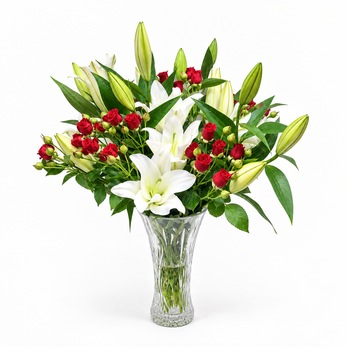 6 white lilies and 6 red baby roses in a clear glass vase