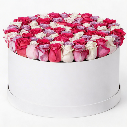 60 mixed red, white, pink, and purple roses arranged in a luxury white flower box with same-day flower delivery in Kuwait.