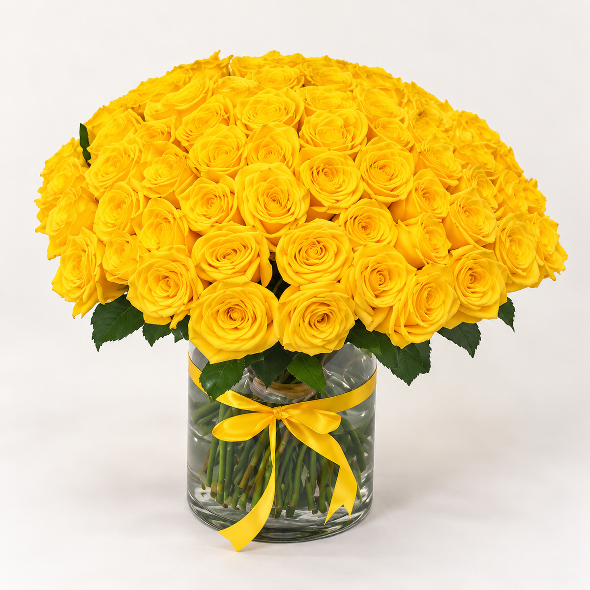 70 yellow roses in a clear glass vase