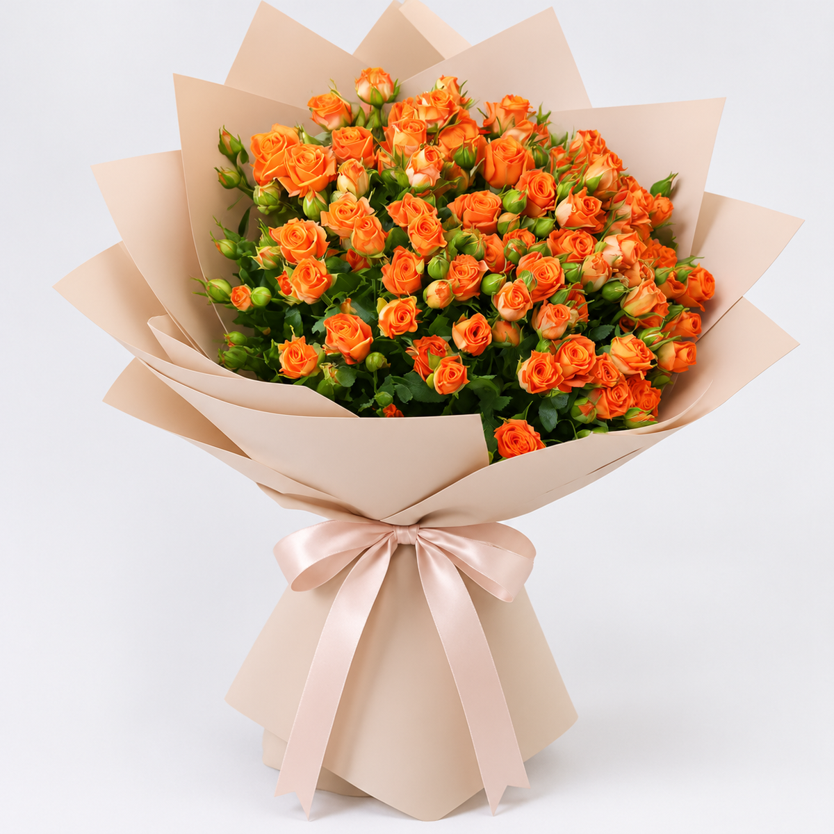 A bouquet of baby orange roses wrapped in beige paper with a pale pink ribbon