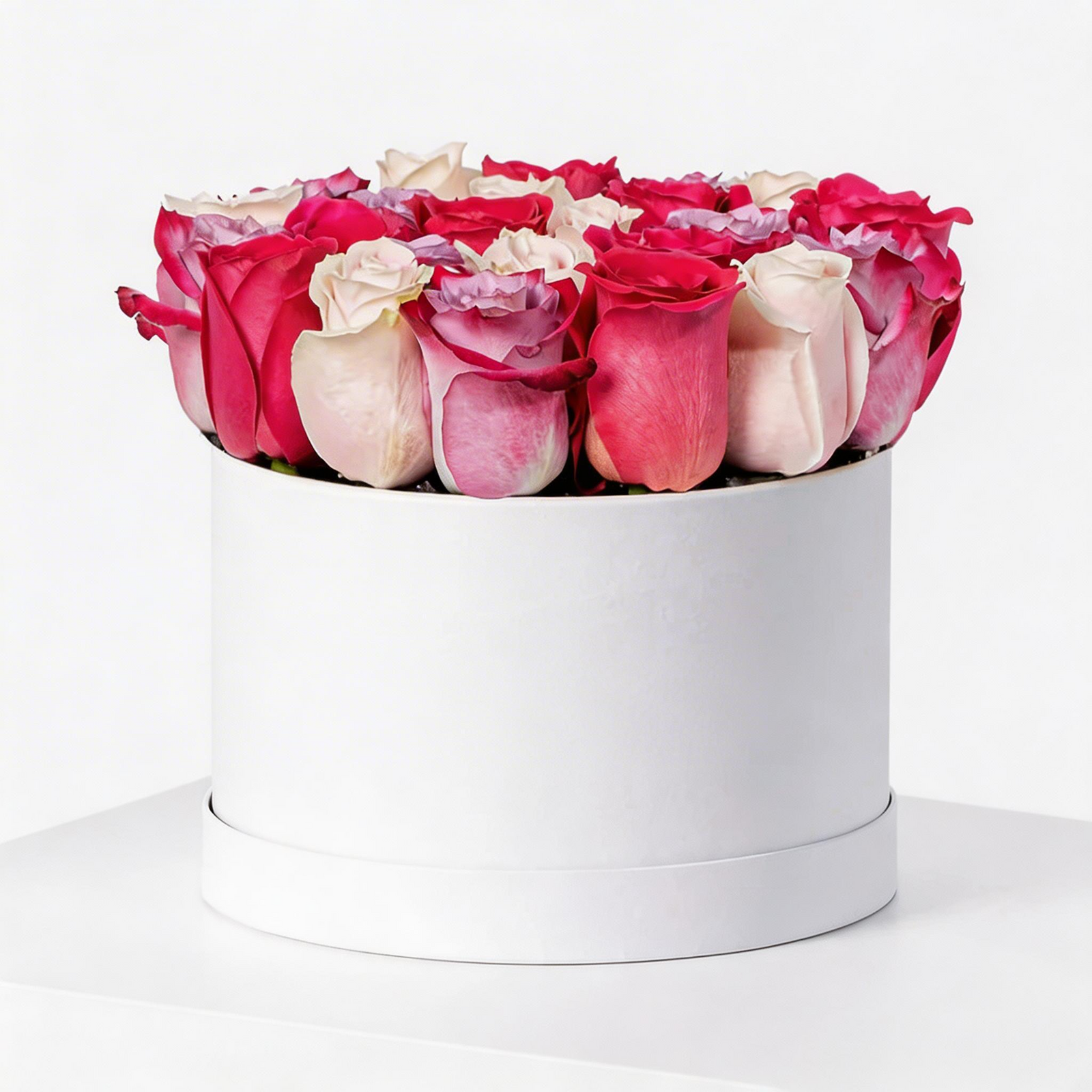 mixed red, white, and purple roses arranged in a luxury white flower box with same-day flower delivery in Kuwait.