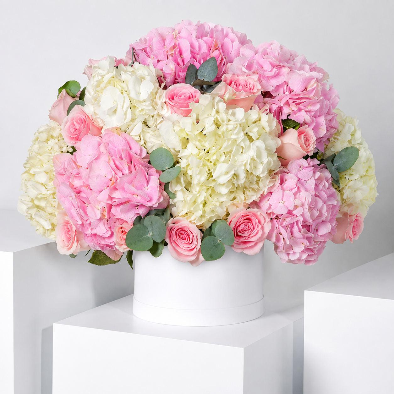 Elegant Pink & White Flower Box with pink hydrangeas, white hydrangeas, white roses and fresh greenery arranged in a luxury flower box for same-day flower delivery in Kuwait.