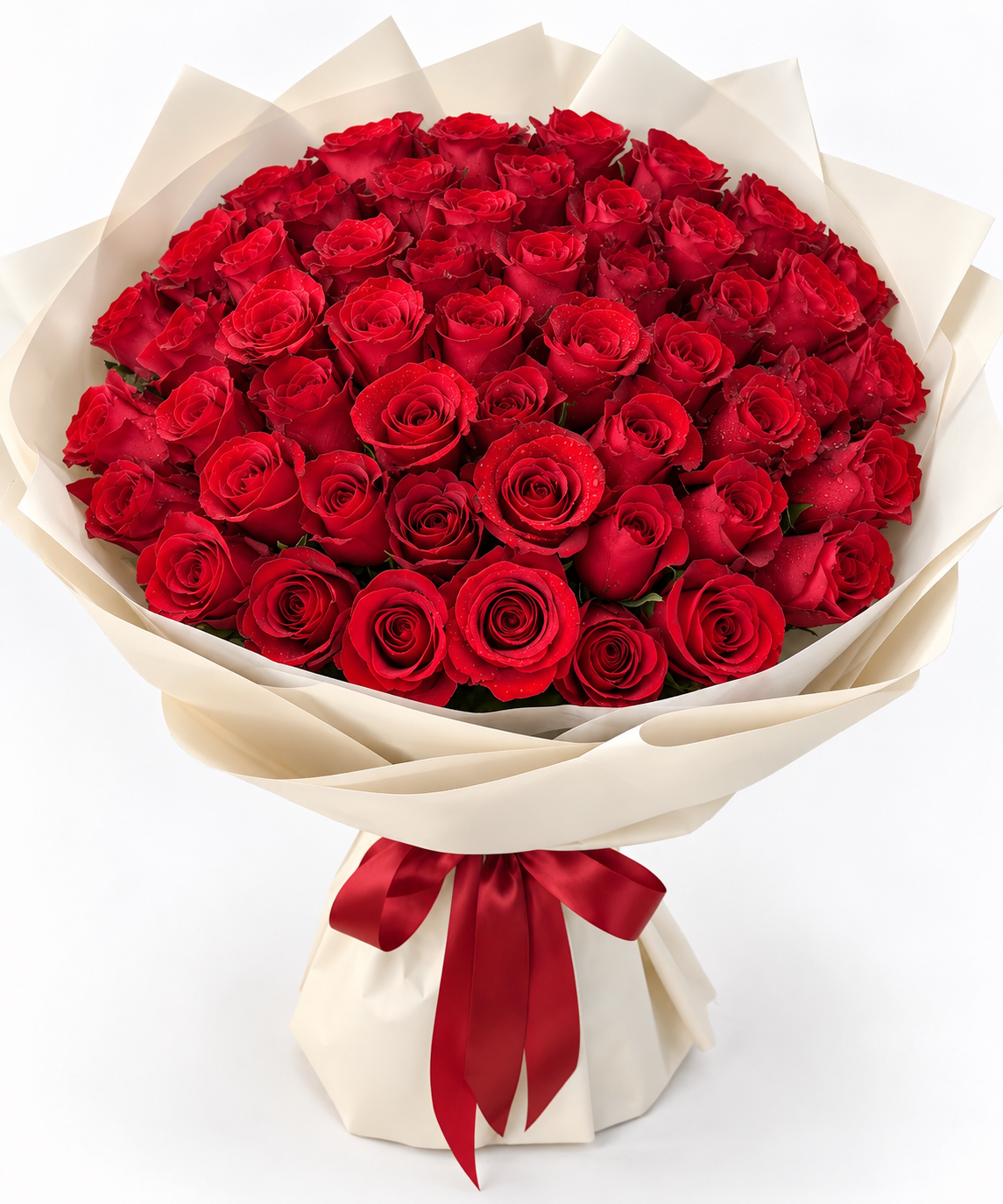 A large bouquet of red roses wrapped in cream-colored paper with a matching red ribbon