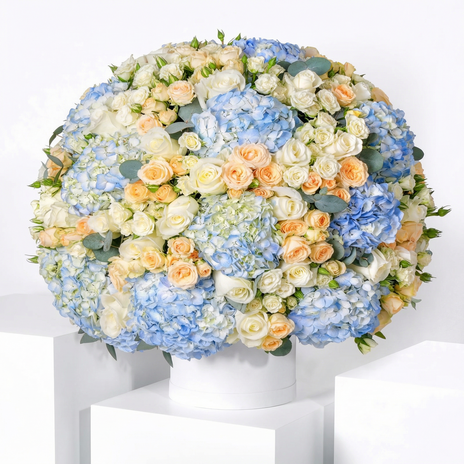 Signature Blue Hydrangea Flower Box with premium blue hydrangeas, white roses and peach baby roses arranged in a luxury white flower box in Kuwait.