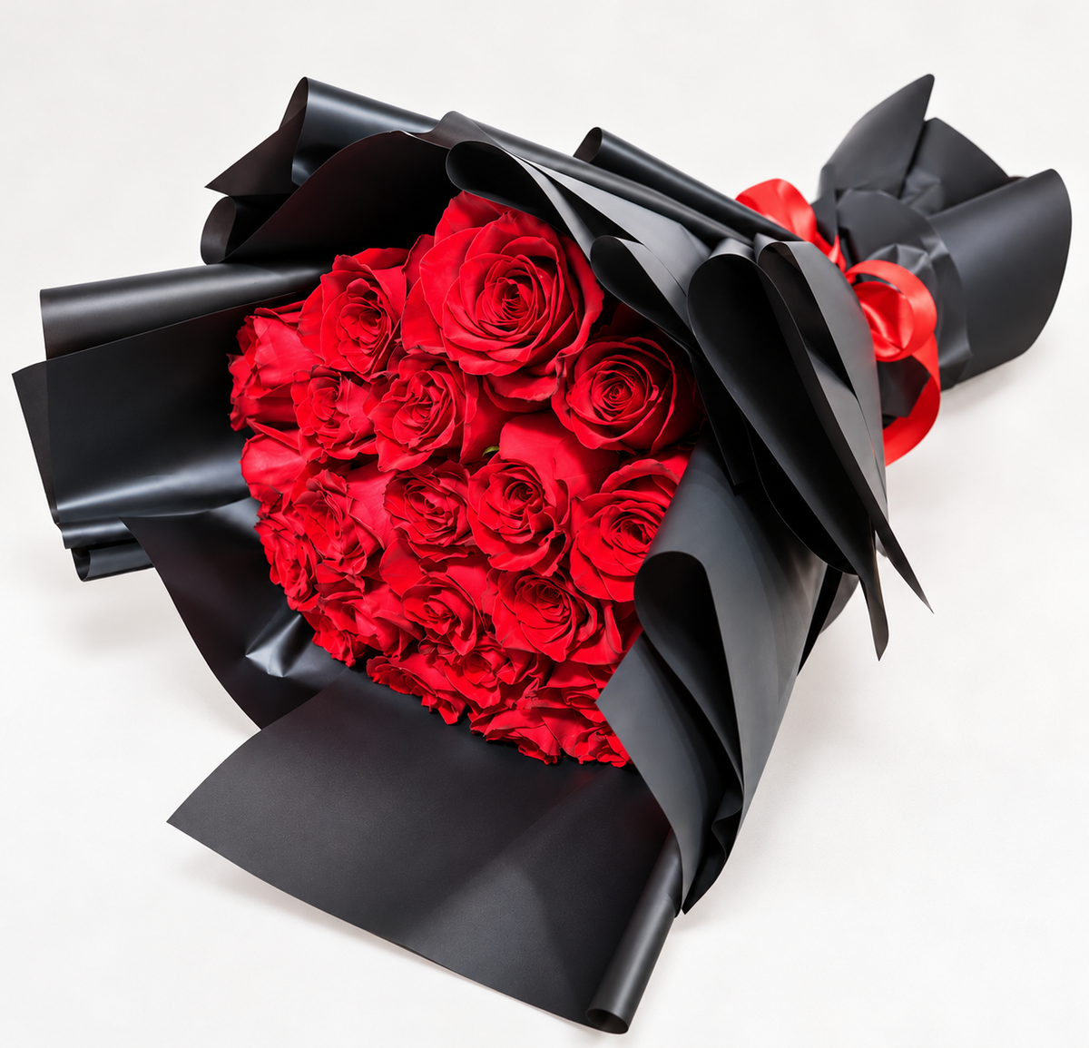 Bouquet of 21 fresh red roses arranged in elegant black wrapping with a red satin ribbon.